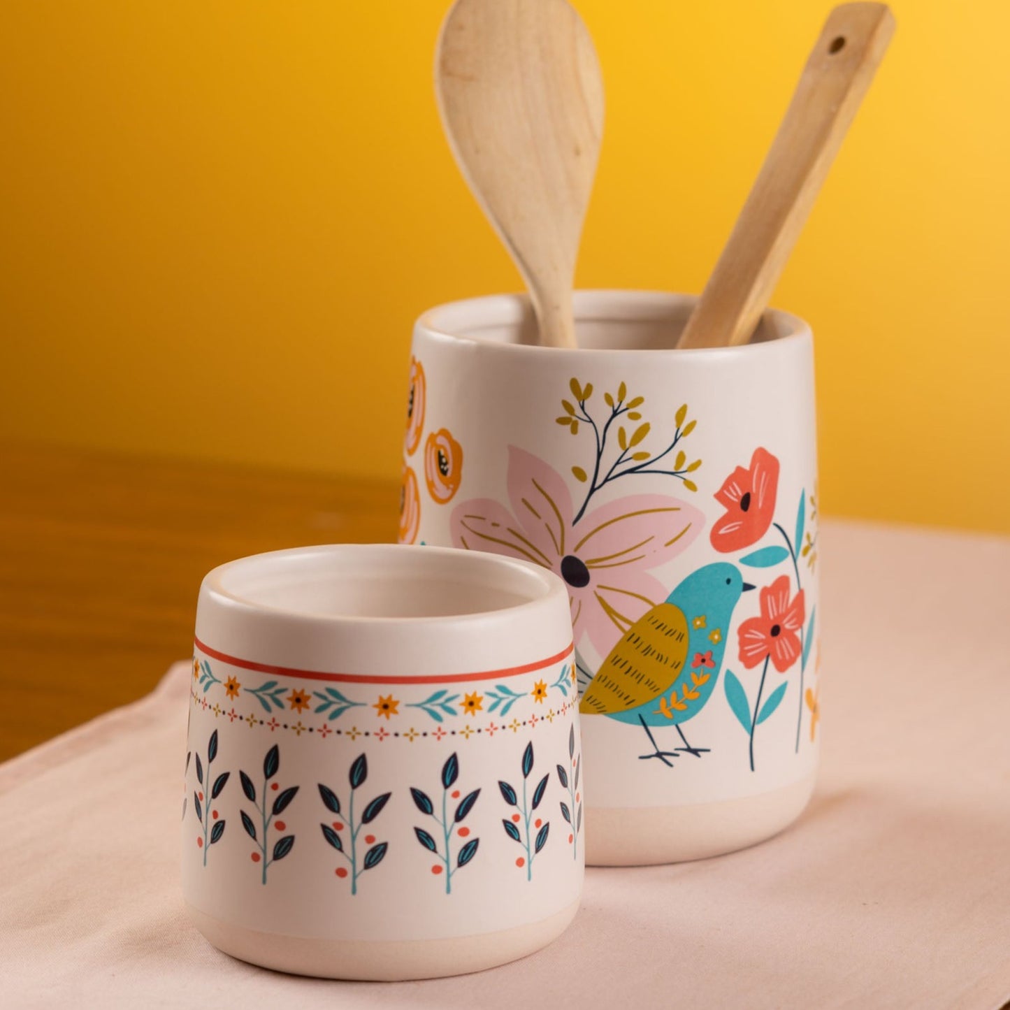 Ava crocks on a white table with a yellow background.