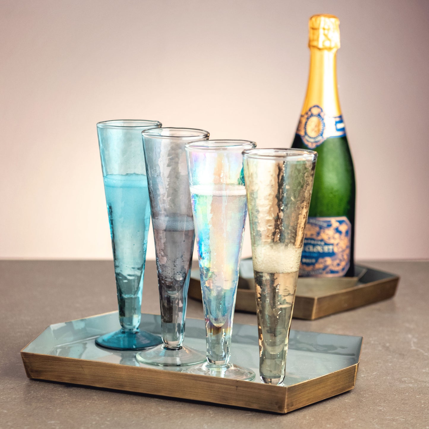 Catalina Champagne Flutes on a tray with a champagne bottle in the background.