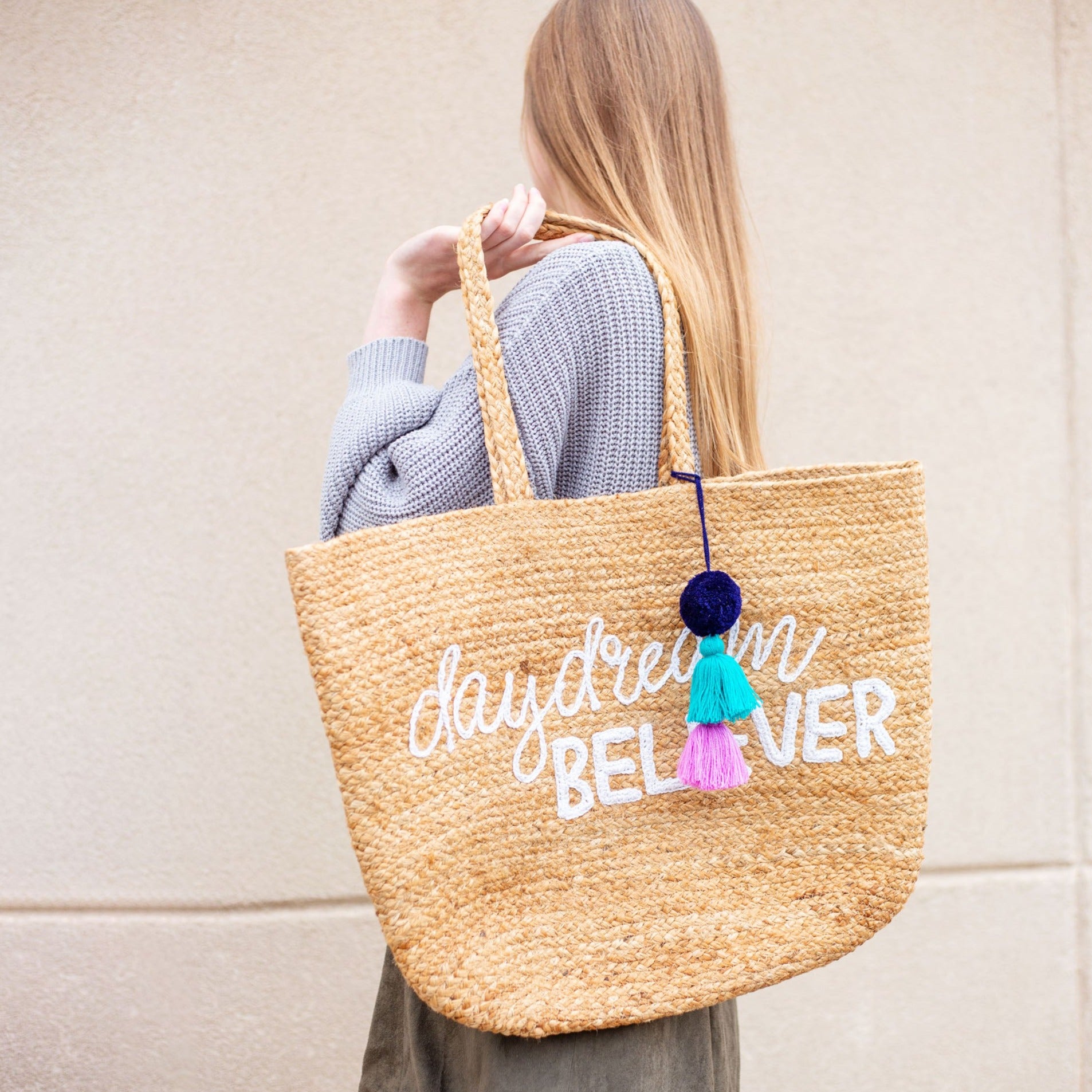 Woman holding Daydream Believer Jute Beach Bag