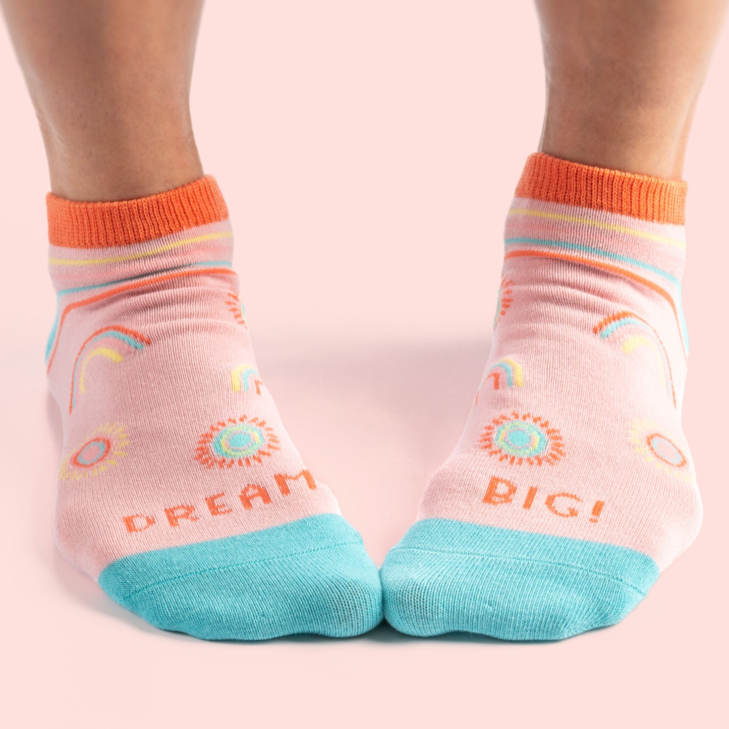 Dream Big Ankle Socks against a pink background.