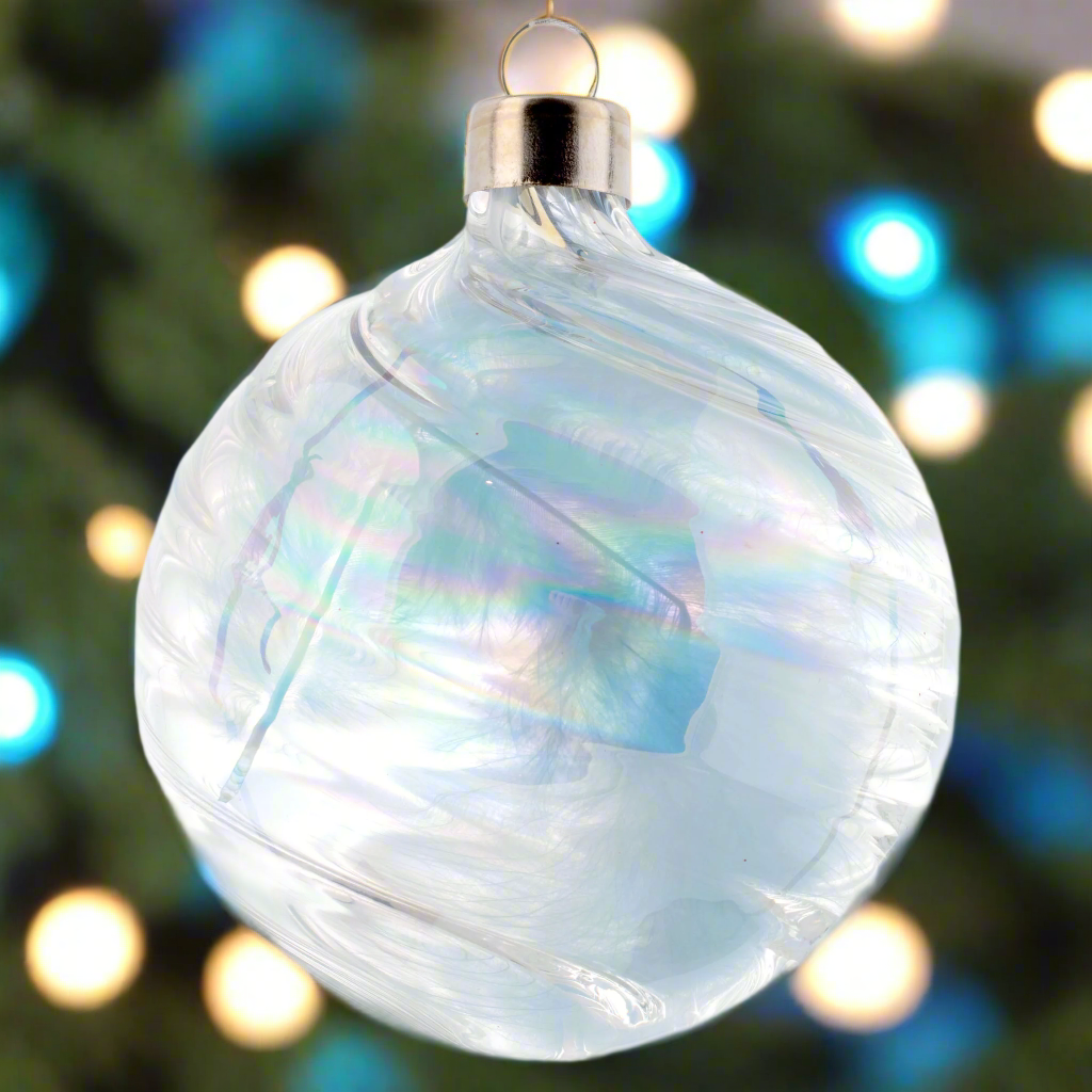 Ball Feather Cloud Sea Blue Ornament with holiday lighting in the background.