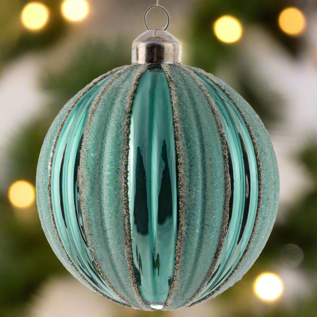 Ball Matte Striped Fluted Teal Ornament holiday lighting in the background.