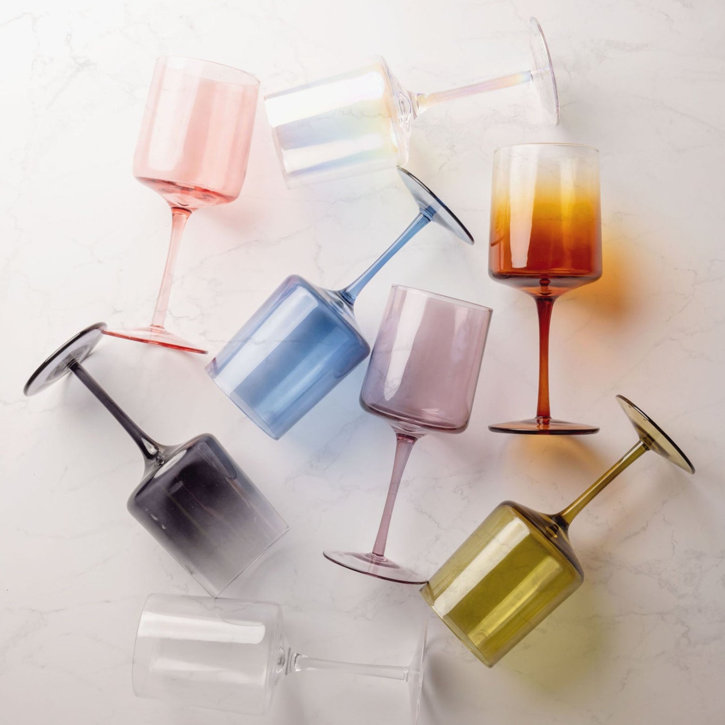 Mid century wine glasses on a marble countertop.