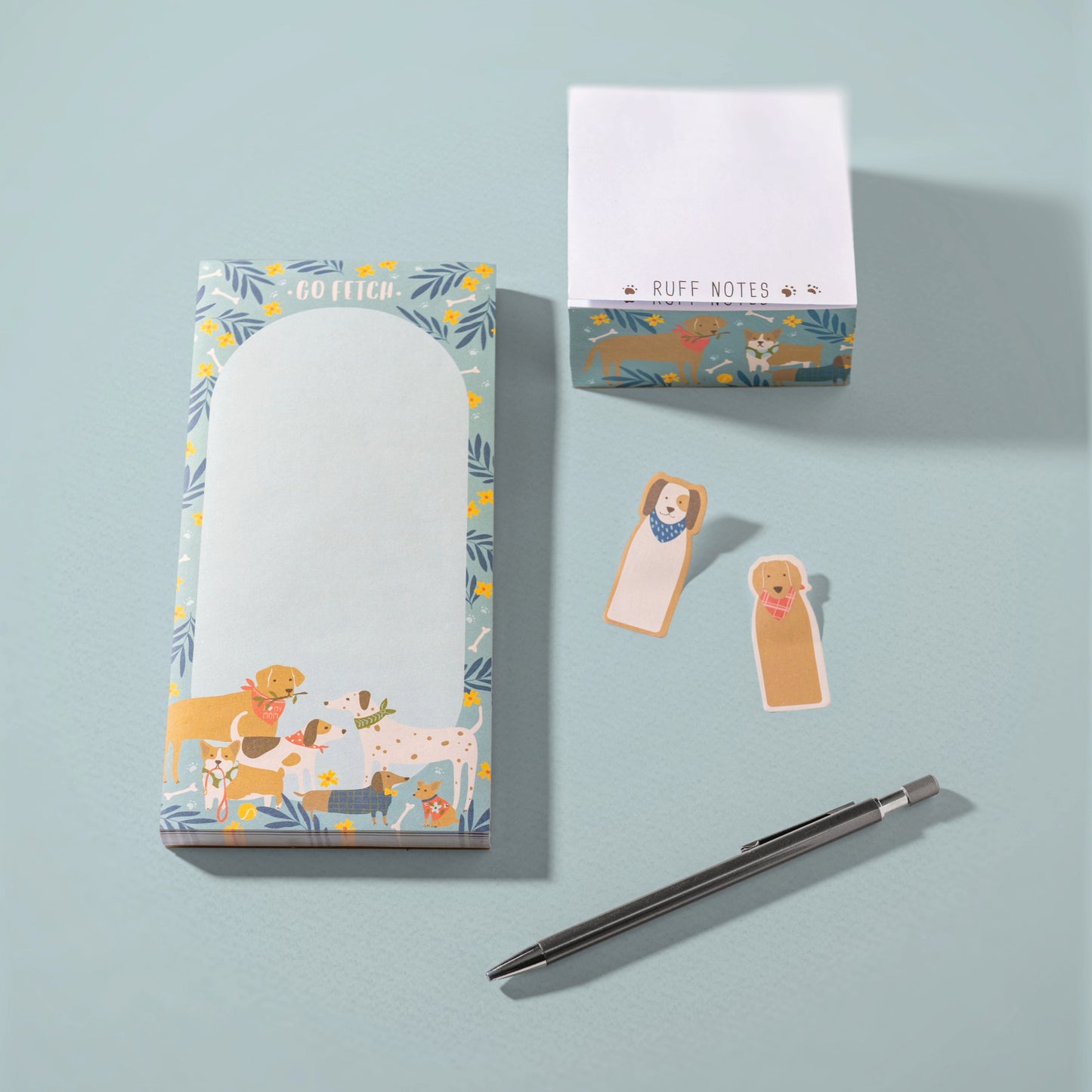 Dog long magnetic notepad, block notepad, and sticky tabs against a blue background.