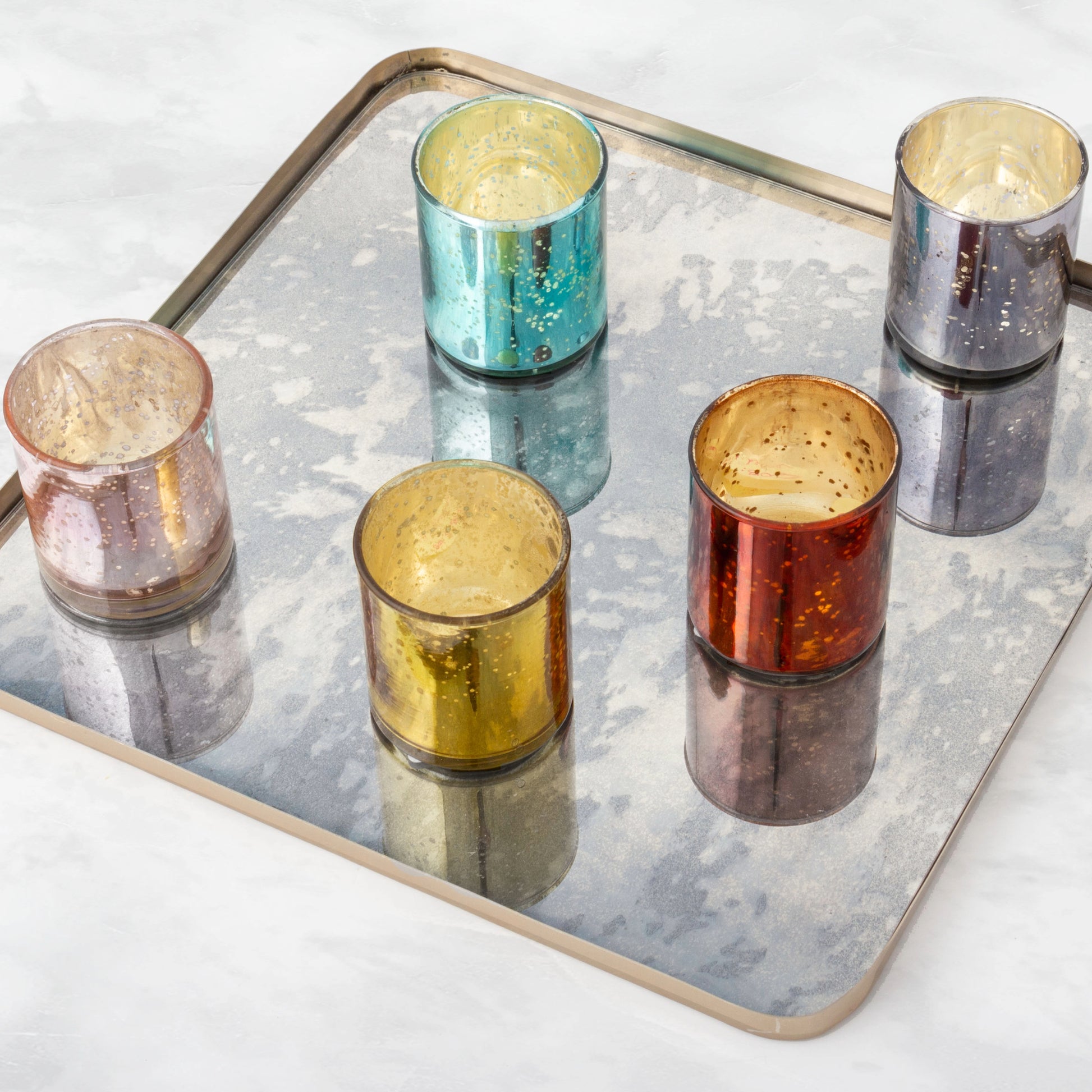 Mercury glass votives on a tray.