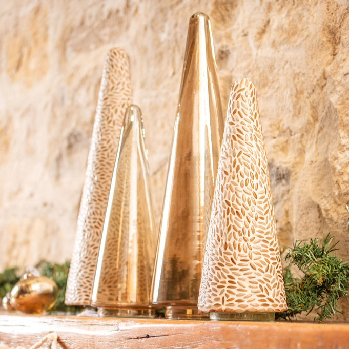 Decorative trees on a mantle.