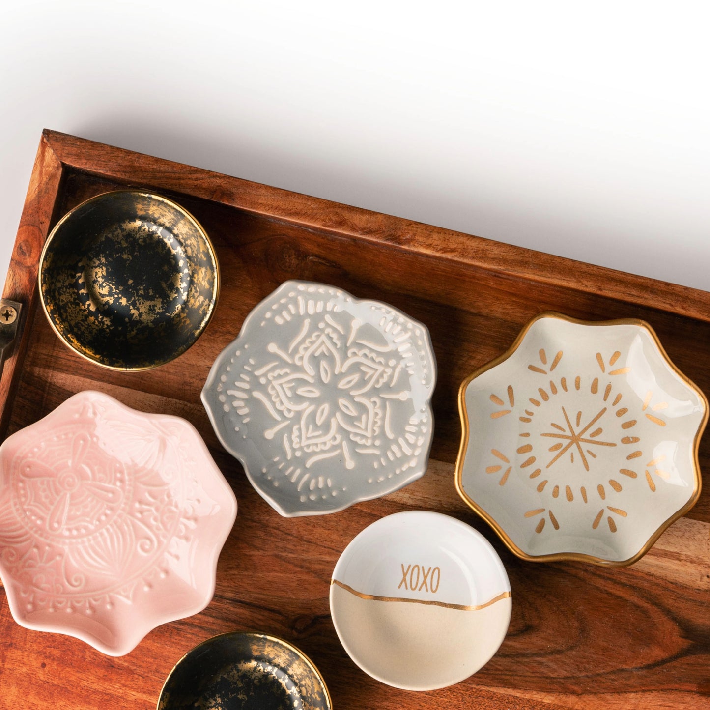Shaped trinket trays on a wooden tray.
