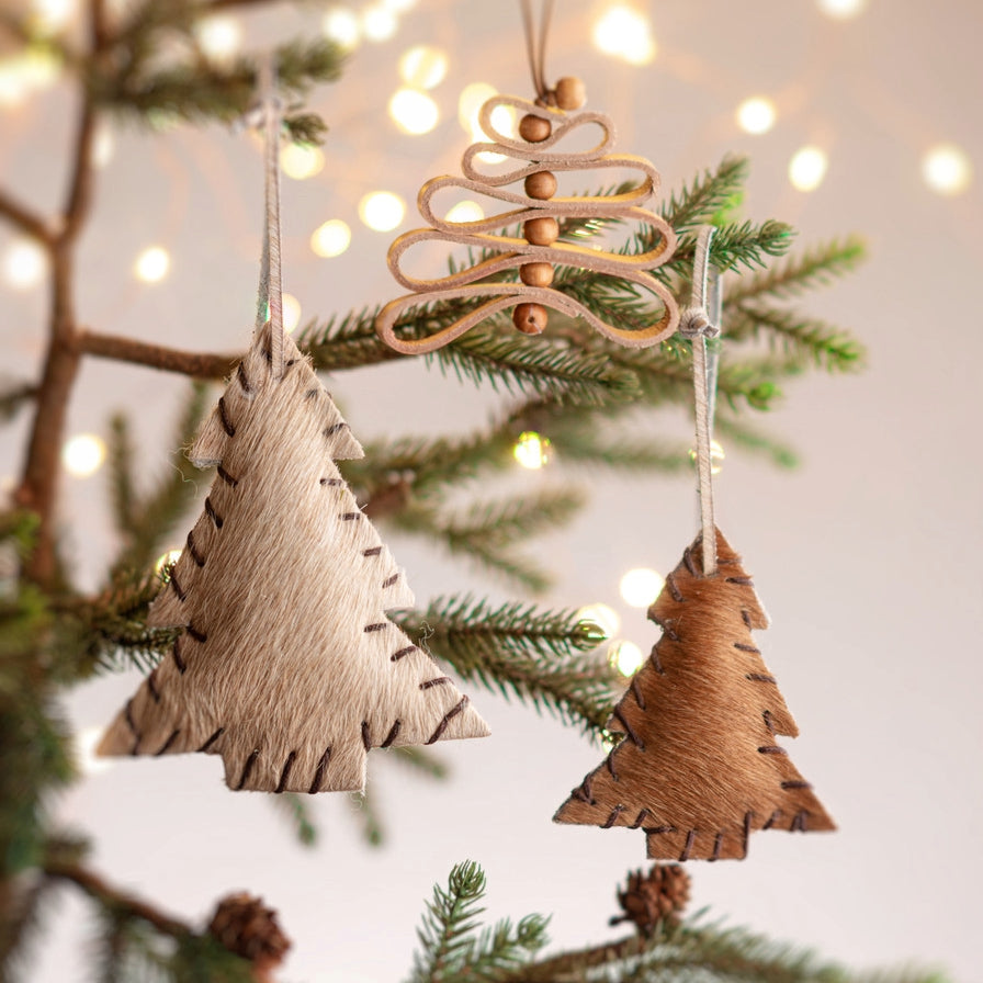Leather Beaded Tree Ornament and leather tree ornaments hanging on a tree.