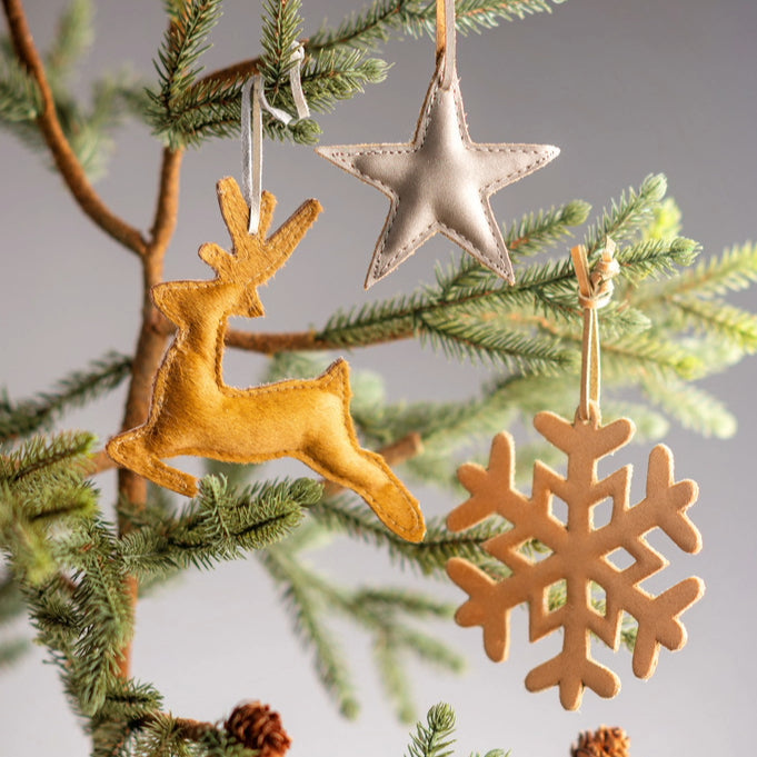 leather ornaments hanging from tree.