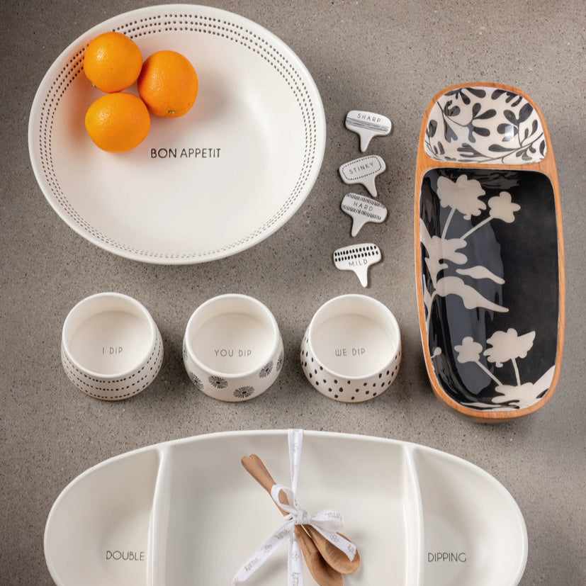 Milo Bowl, milo bowls, cheese labels and platteres on a gray counter.