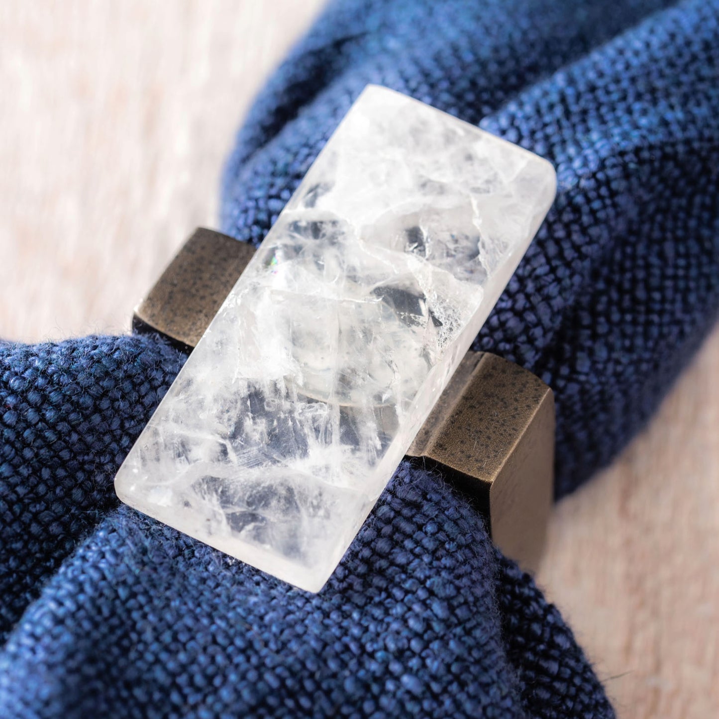 Clear Rock Crystal Napkin Rings around a napkin.