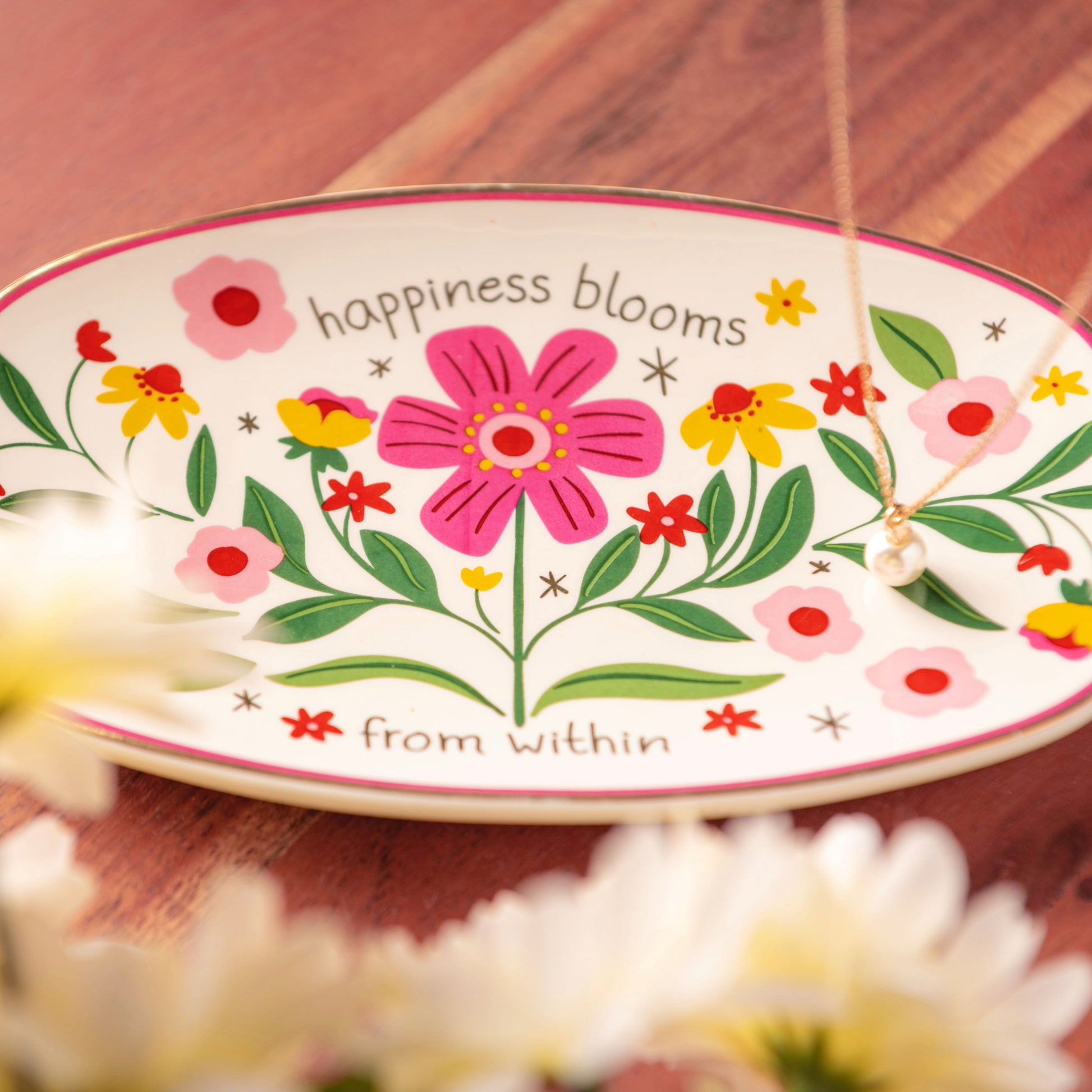 Happiness Blooms Oval Trinket Tray on a table.