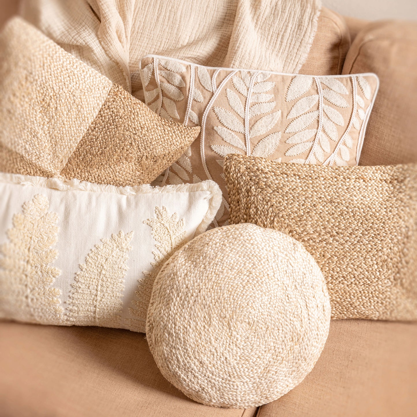 White Round Jute Pillow on a couch