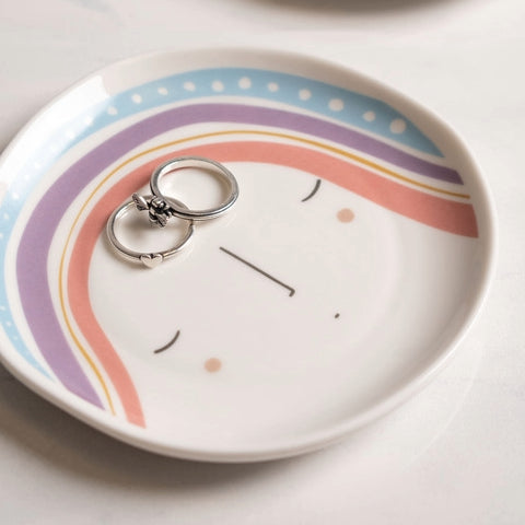 Rainbow Reyna Trinket Tray with rings on it.