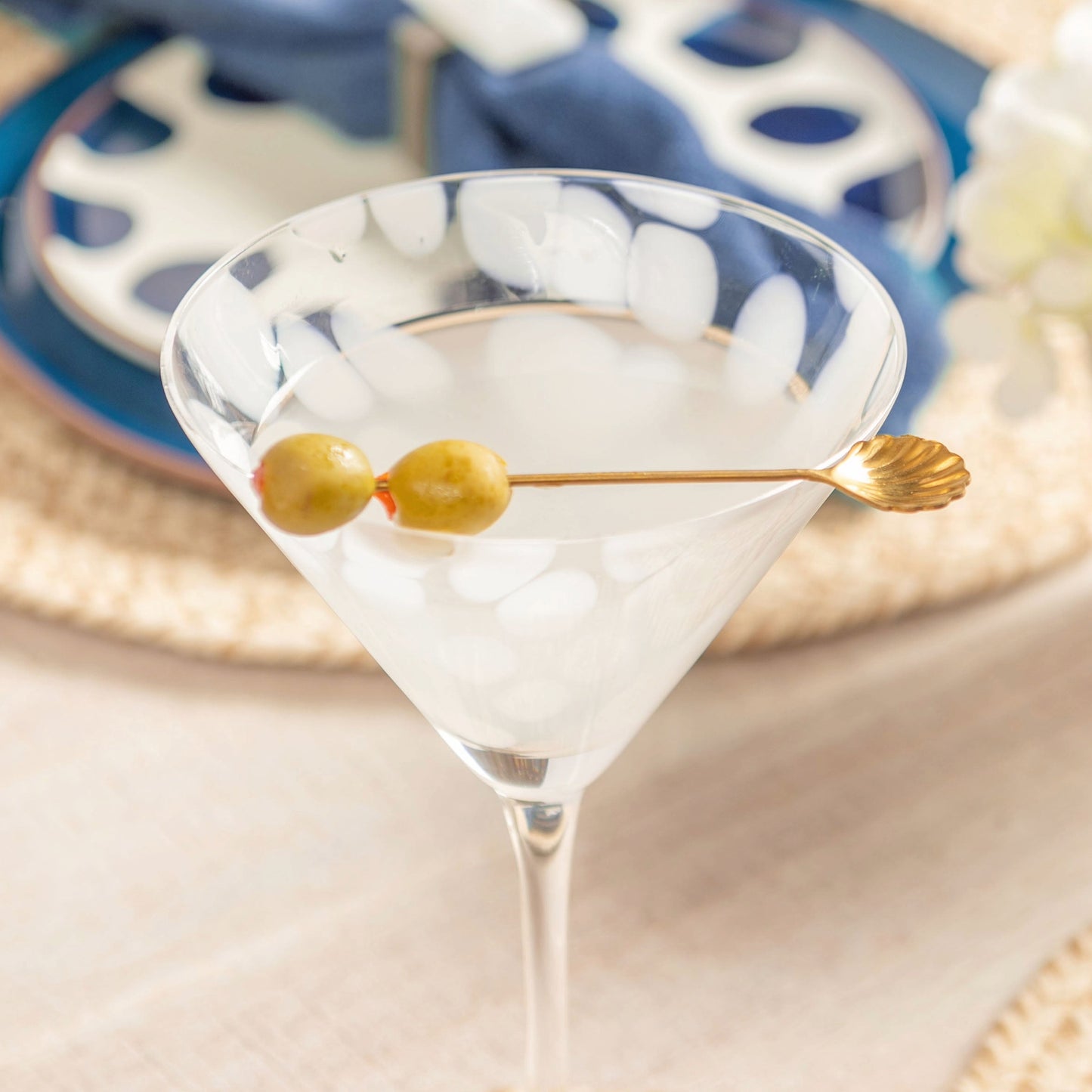 Gold Seashell Cocktail Pick on cheena martini glass.