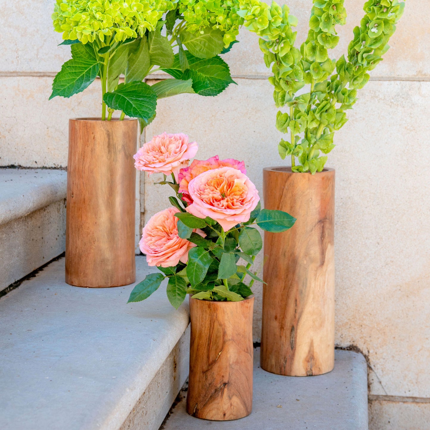 Natural Sierra Wood Vases with florals on stairs.