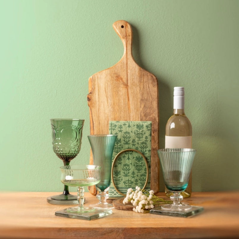 Thistle Tea Towel, vintage coupe glass, aria flute, aria wine glass, and gold napkin ring holder on a table.