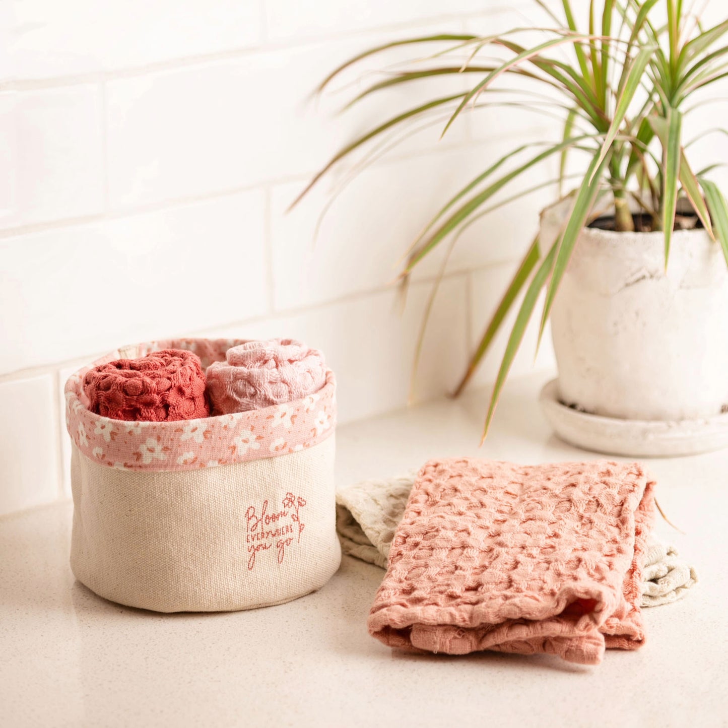 Bloom Waffle Weave Dishcloth Set With Canvas Holder on a kitchen counter.