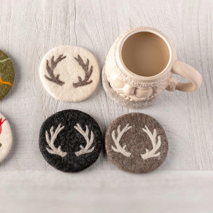 Stag Felt Coasters on a table with a cream Santa mug