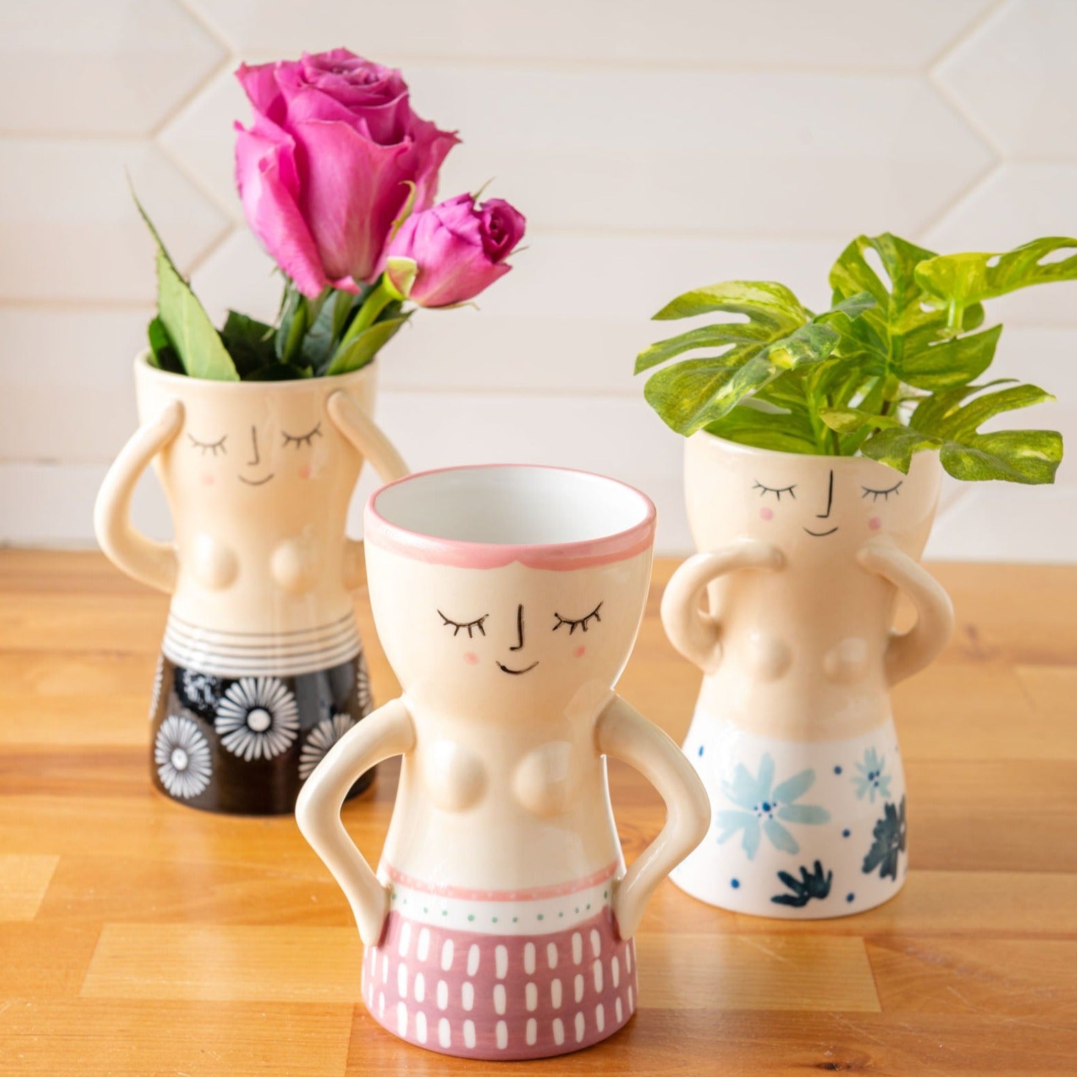 Reyna Busty Lady Vases on a table. 