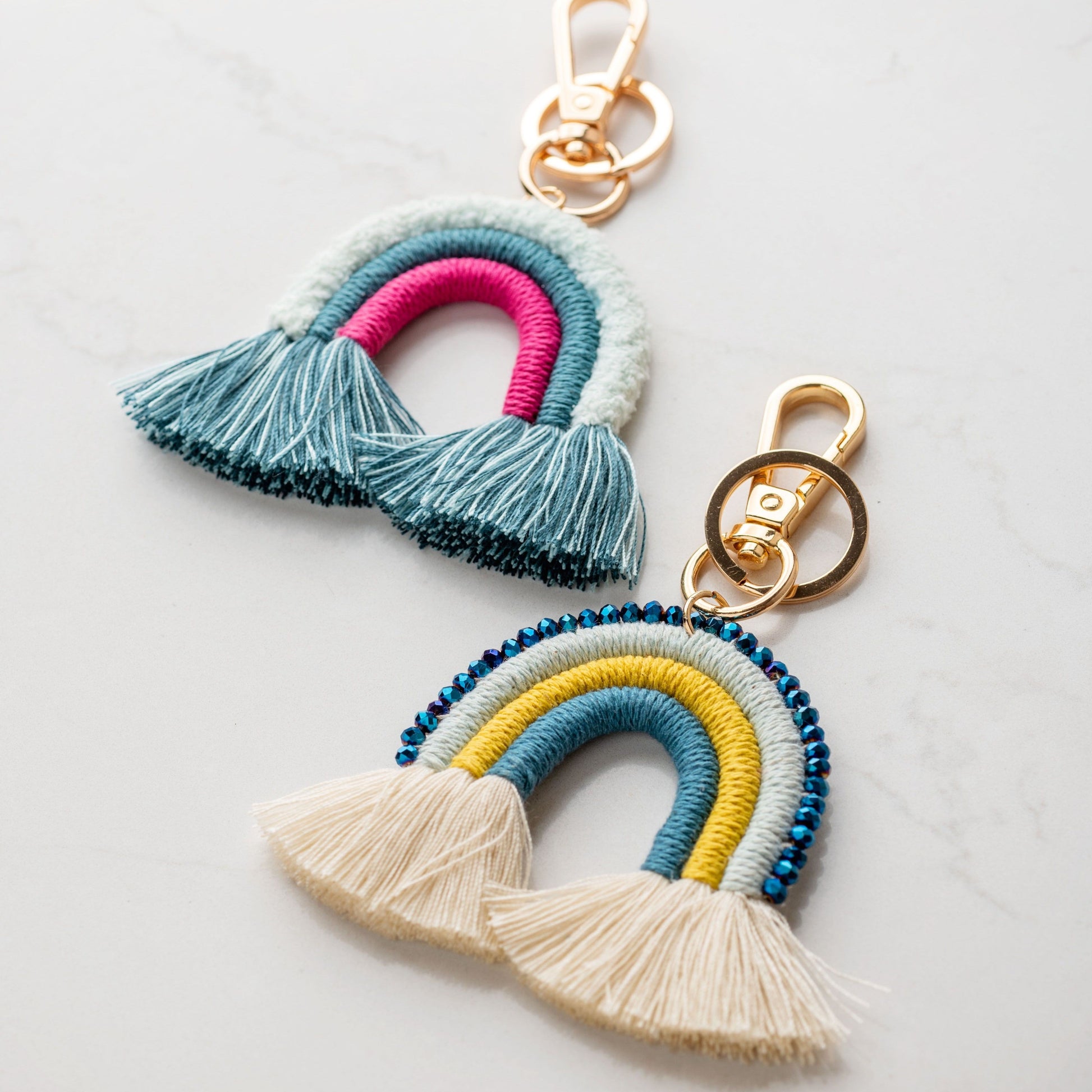 Rainbow keychains against a white background. 