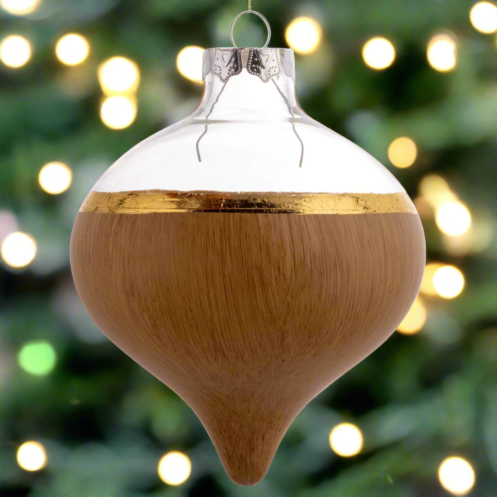Wood Painted Glass Ornaments with holiday lighting in the background. 