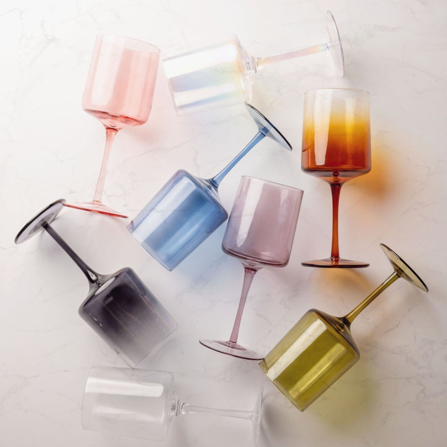 Mid century wine glasses on a marble countertop. 