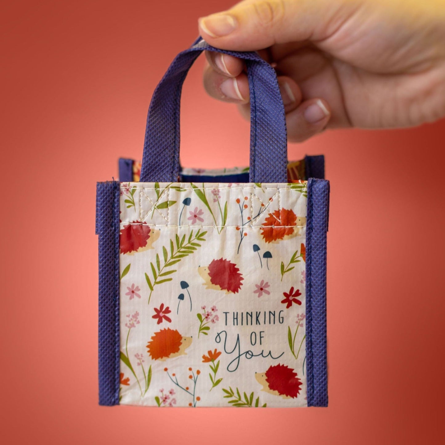 Hedgehog Recycled Tiny Gift Bag against a pink background. 