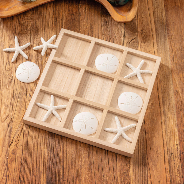 Beach tic tac toe on a table.