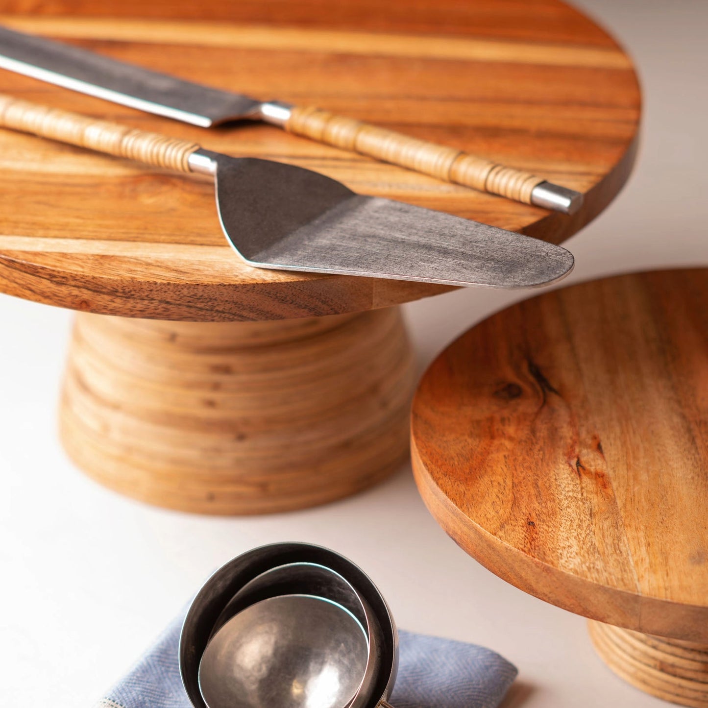 Catalina Cane Wrapped Handle Cake Servers on cake stands. 