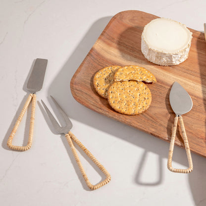 Catalina Cheese Tools on a counter. Serving board with crackers and cheese beside them. 
