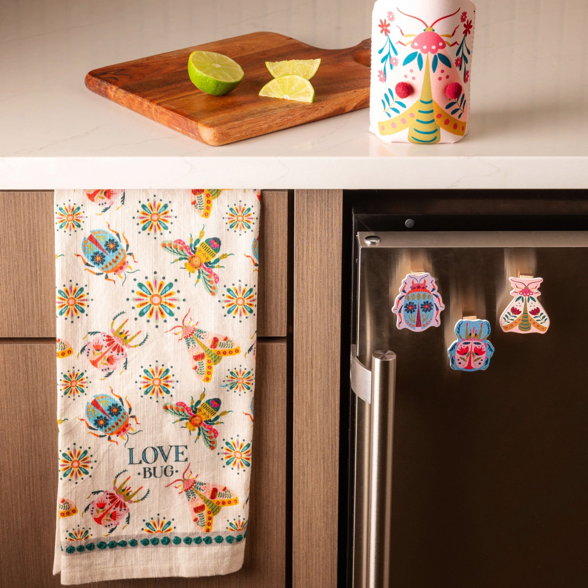 Bugs Eclectic Tea Towel hanging on a kitchen cabinet