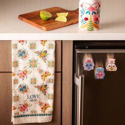 Bugs Eclectic Tea Towel hanging on a kitchen cabinet