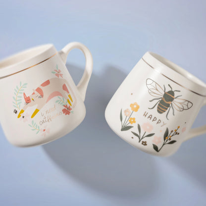 bee and cat floral mugs against a blue background. 