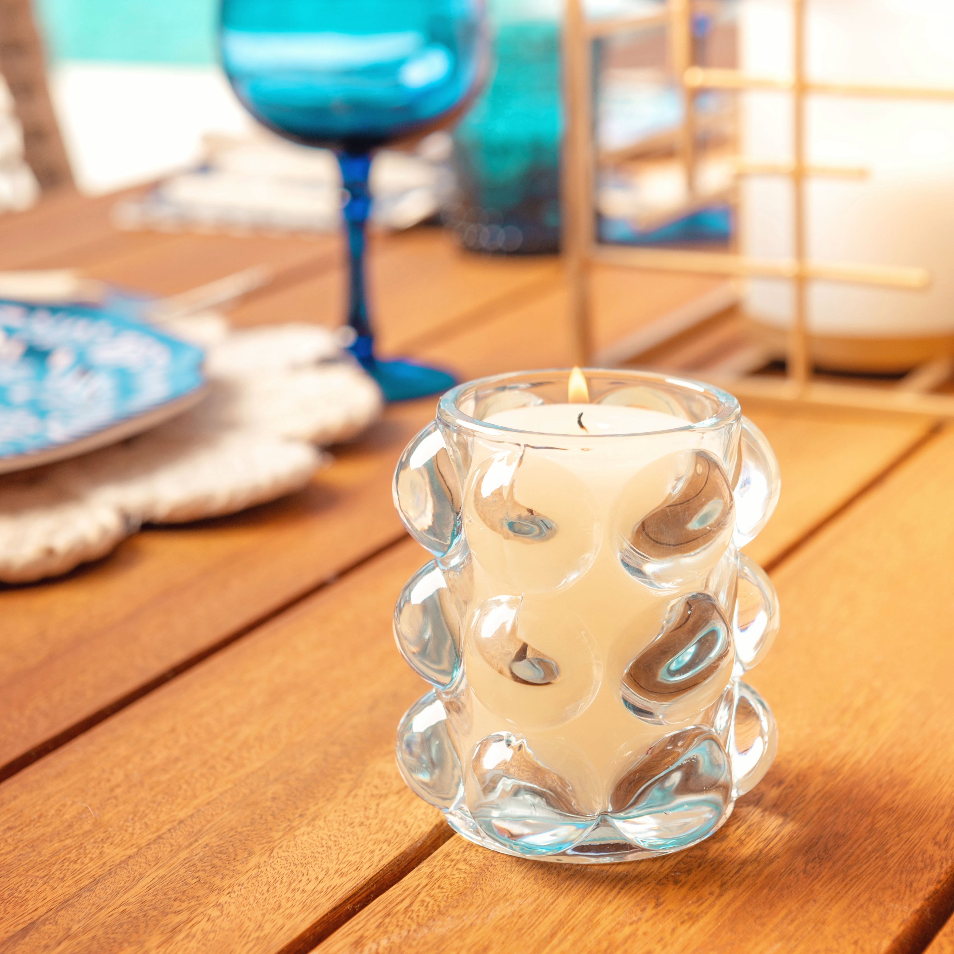 Lucia hobnail votive on a wooden table. 
