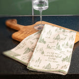 Green toile tea towel on a cutting board.