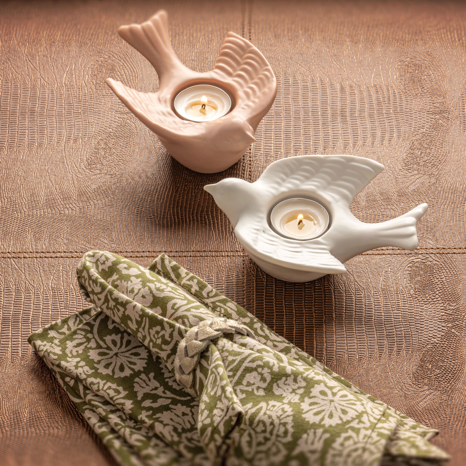 Leather Woven Napkin Rings with birdie tealight holders on a table. 